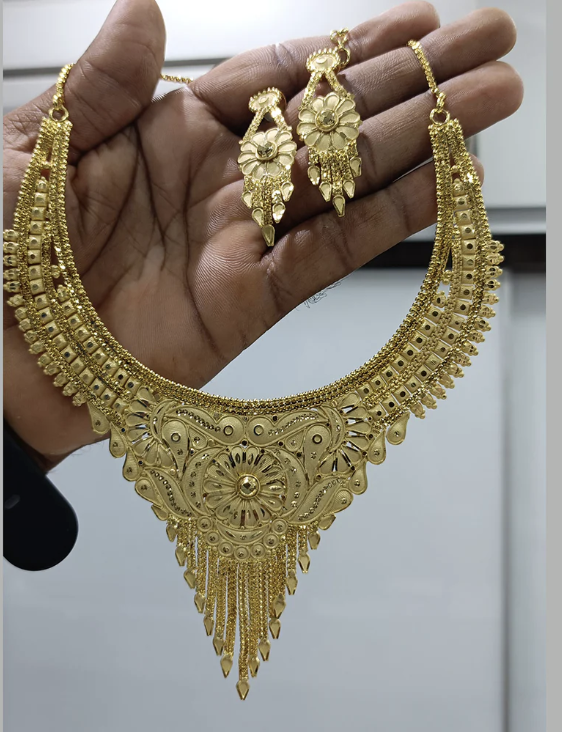 Raw phone photo of gold jewellery necklace and earrings
